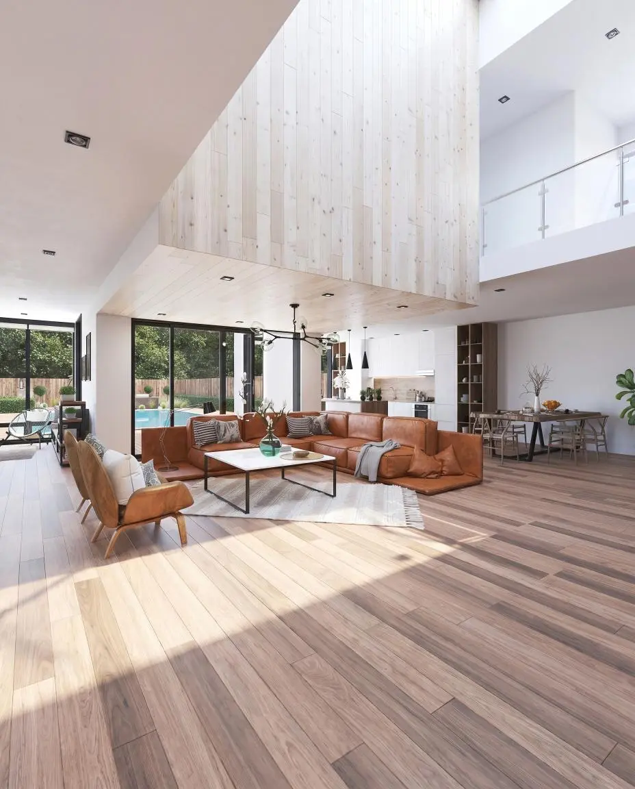 Open-plan living room with leather sectional and kitchen beyond